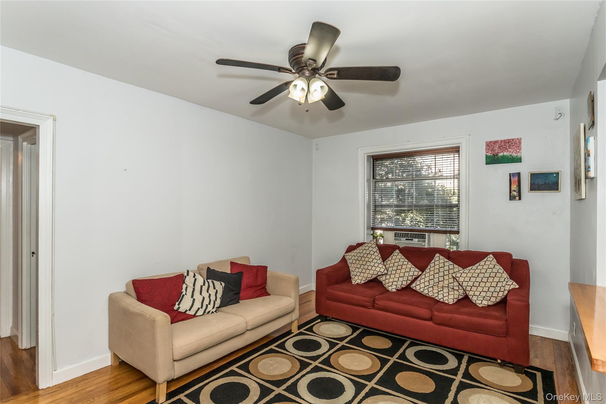 51-28 30th Avenue, Unit 3 Queens, NY 11377 - Photo 3 of 20 Living area with wood finished floors and a ceiling fan