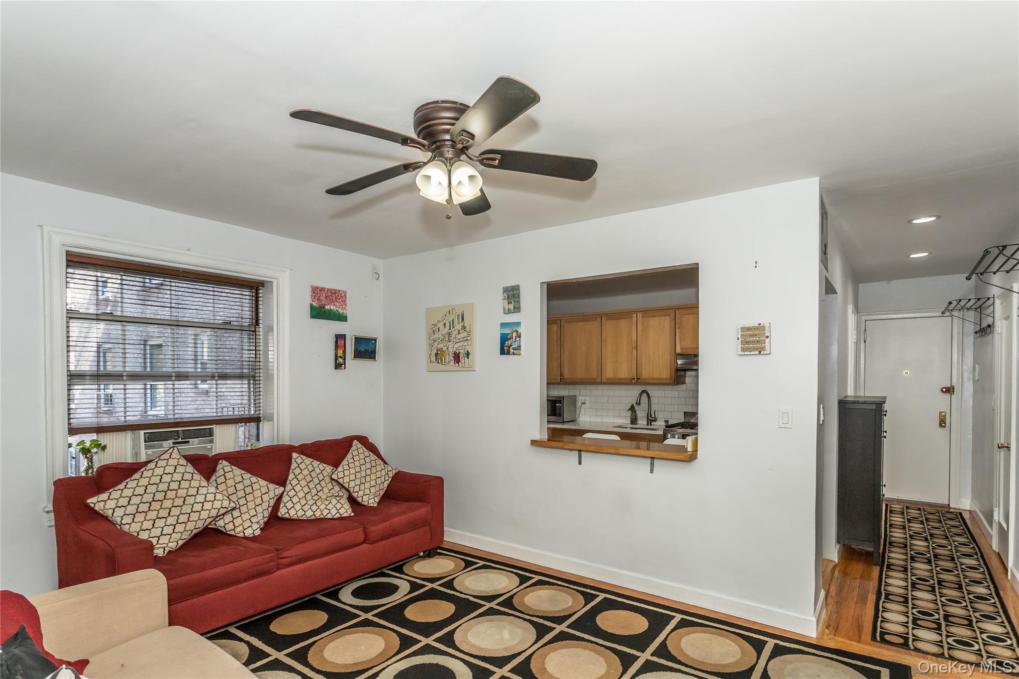 51-28 30th Avenue, Unit 3 Queens, NY 11377 - Photo 4 of 20 Living room with ceiling fan and wood finished floors