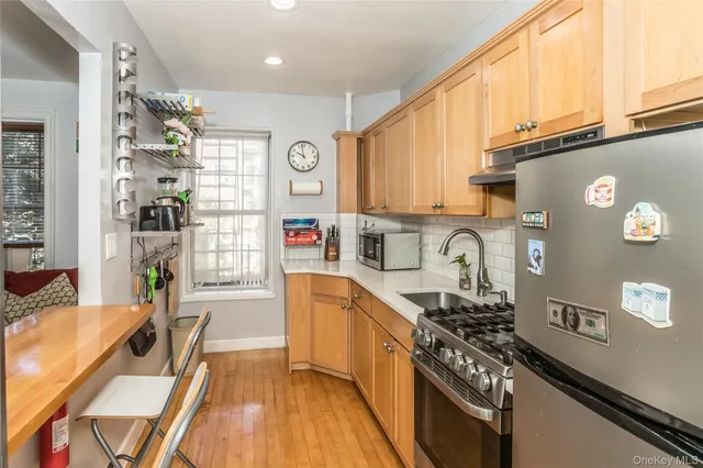 a kitchen with stainless steel appliances granite countertop a stove and a refrigerator