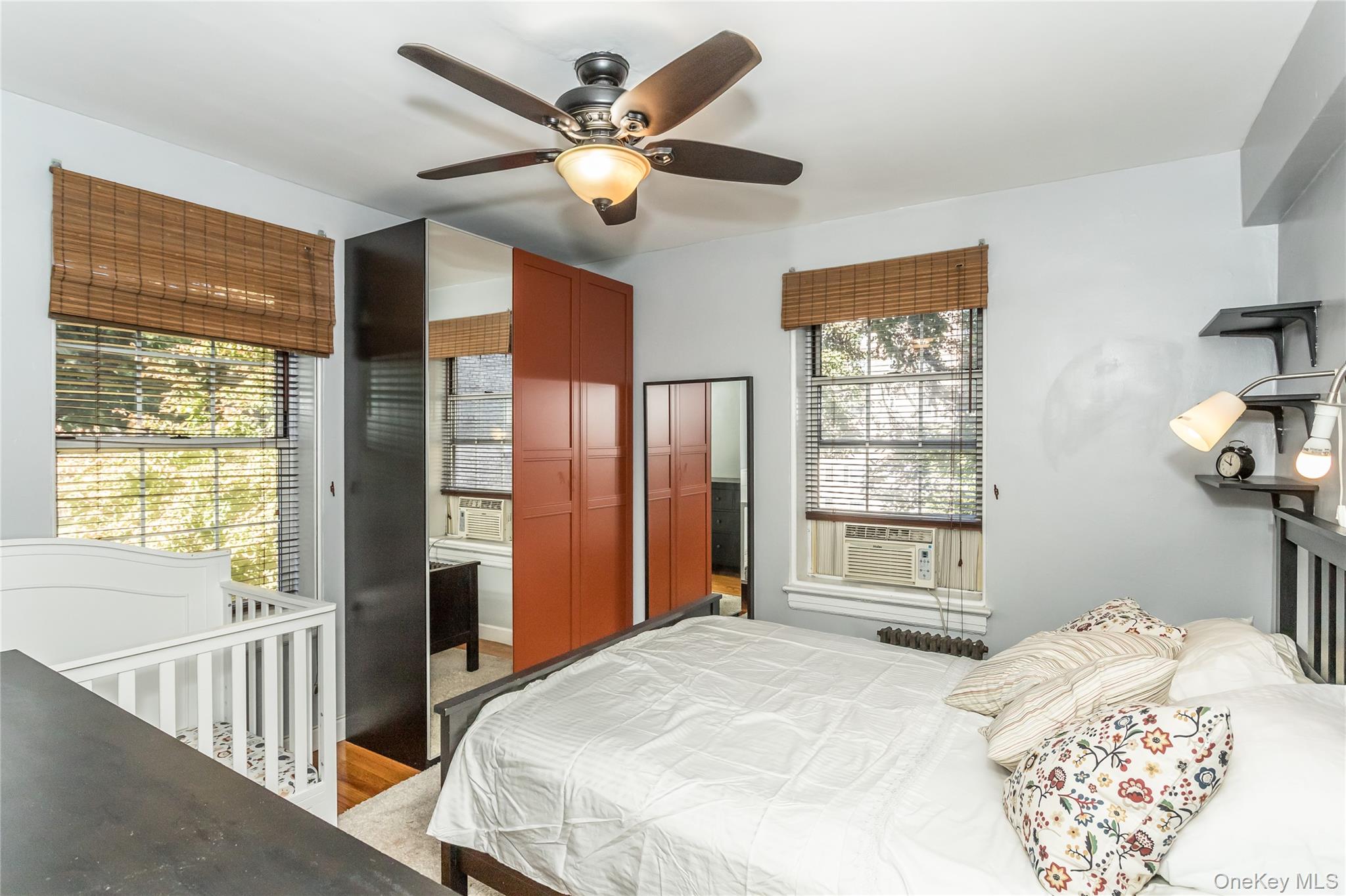 51-28 30th Avenue, Unit 3 Queens, NY 11377 - Photo 9 of 20 Bedroom with ceiling fan, cooling unit, and light wood-style flooring