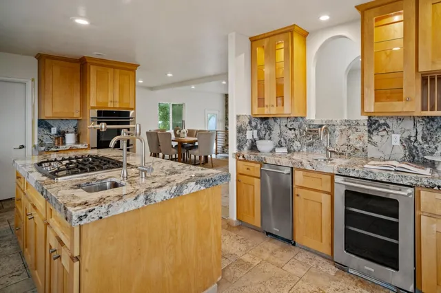a kitchen with stove a sink and a refrigerator