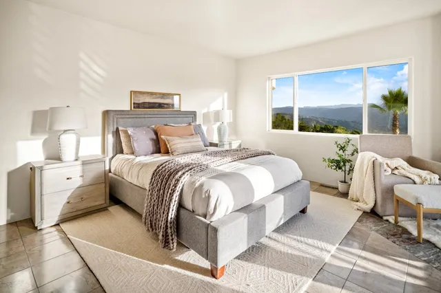 a bedroom with a large bed and a window