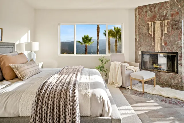 a bedroom with a bed and a fireplace