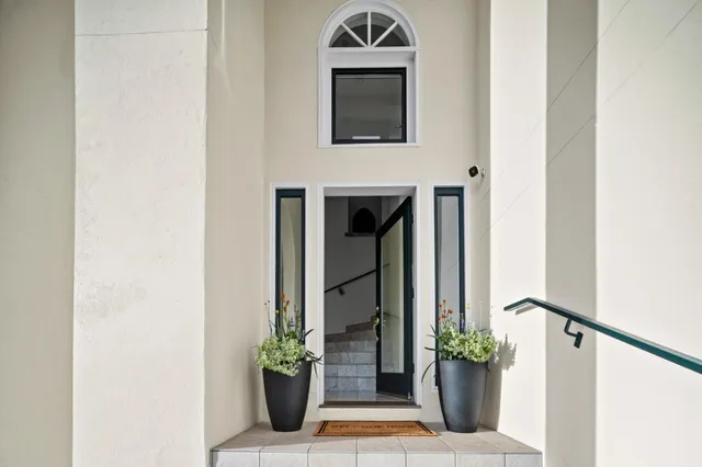 a view of a hallway with potted plants