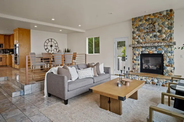 a living room with furniture a table and a fireplace