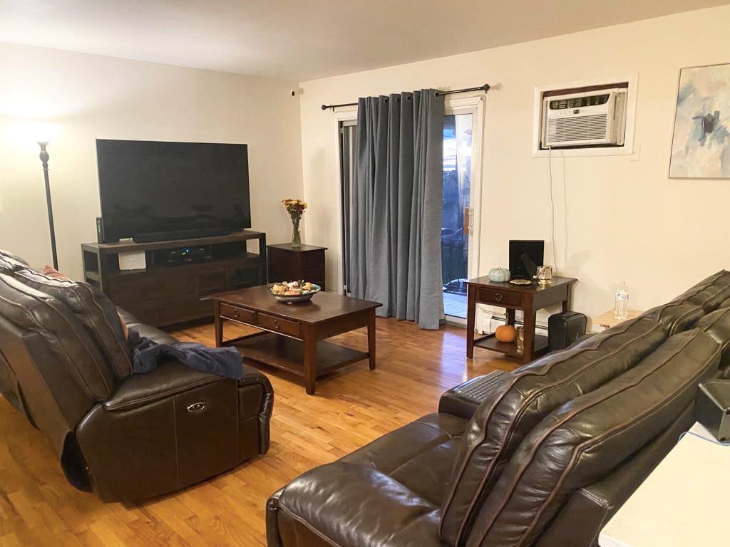 34 Trask Avenue, Unit 2 Bayonne, NJ 07002 - Photo 2 of 11 a living room with furniture and a flat screen tv