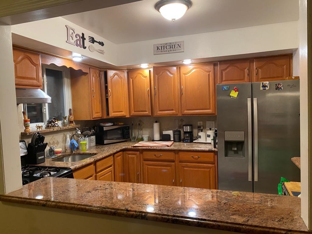 34 Trask Avenue, Unit 2 Bayonne, NJ 07002 - Photo 4 of 11 a kitchen with stainless steel appliances granite countertop a sink stove and refrigerator