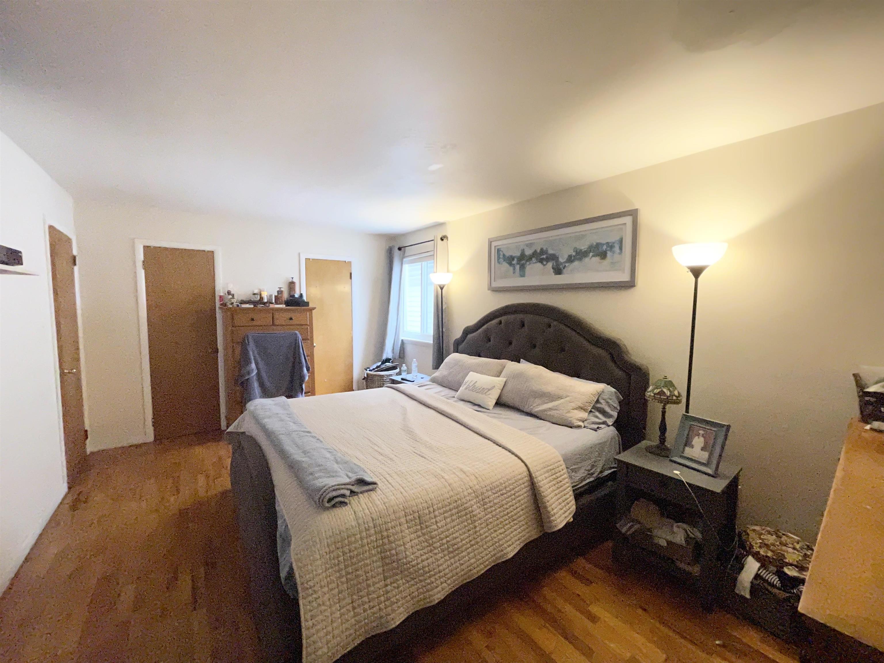 34 Trask Avenue, Unit 2 Bayonne, NJ 07002 - Photo 6 of 11 a bedroom with a bed and wooden floor