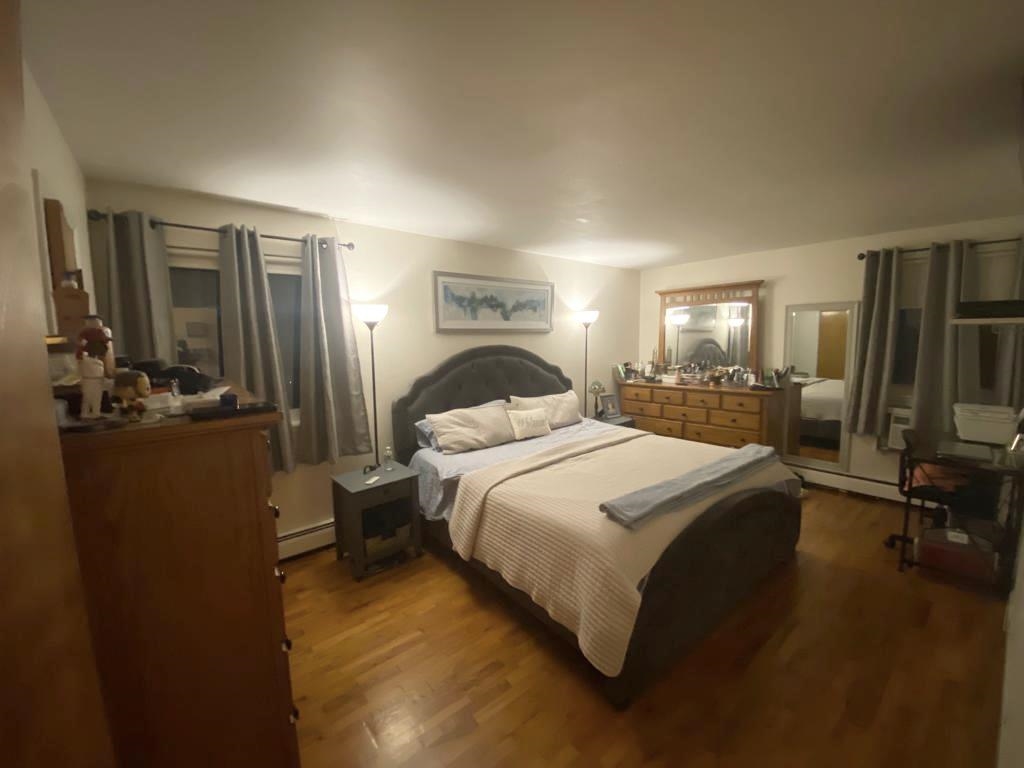 34 Trask Avenue, Unit 2 Bayonne, NJ 07002 - Photo 7 of 11 a bedroom with a bed a mirror and desk