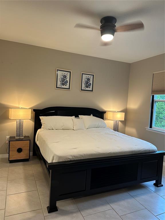 1276 Enbrook Loop Naples, FL 34114 - Photo 12 of 15 a bedroom with a bed and a lamp