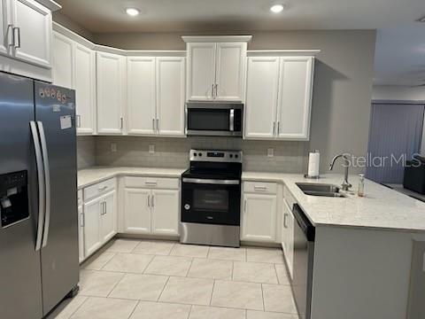 1276 Enbrook Loop Naples, FL 34114 - Photo 7 of 15 a kitchen with a sink stove and refrigerator