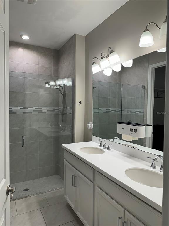 1276 Enbrook Loop Naples, FL 34114 - Photo 8 of 15 a bathroom with a double vanity sink mirror and shower