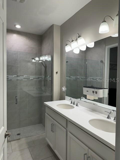 1276 Enbrook Loop Naples, FL 34114 - Photo 9 of 15 a bathroom with a double vanity sink mirror and shower