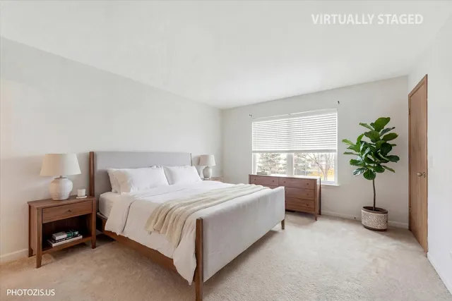 a bedroom with a bed and a potted plant