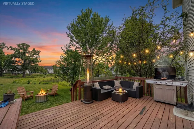a view of a patio with dining table and chairs with wooden floor and fence