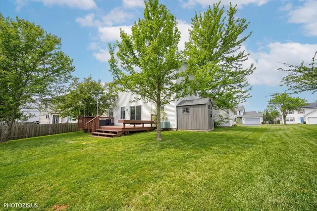 a view of a house with a yard and sitting area