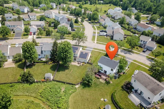 an aerial view of residential houses with outdoor space