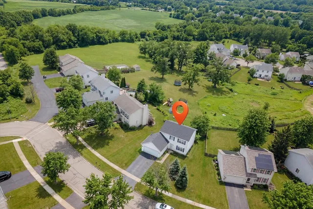 an aerial view of a house with a yard