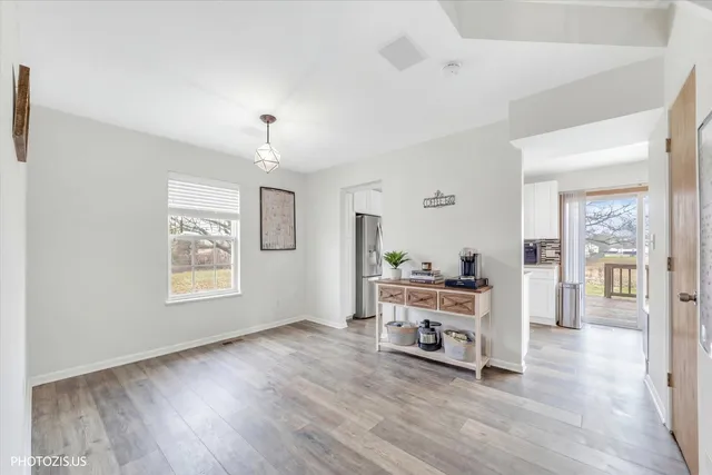 a view of a bedroom with window wooden floor and windows