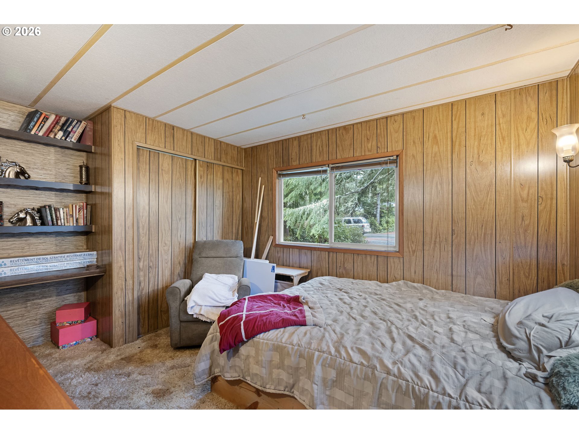4826 Rhododendron Loop Florence, OR 97439 - Photo 20 of 41 a bedroom with a bed and a window