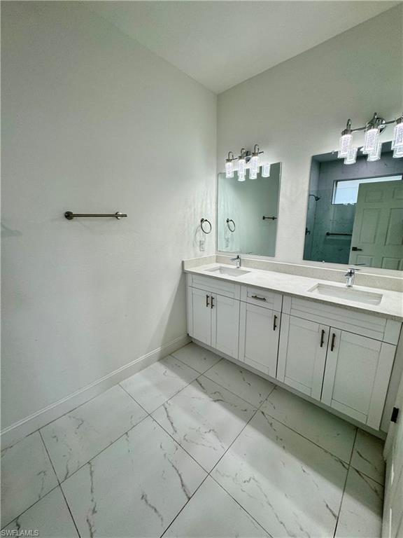 3743 Kenyon Street Fort Myers, FL 33905 - Photo 8 of 18 a spacious bathroom with a double vanity sink and a mirror