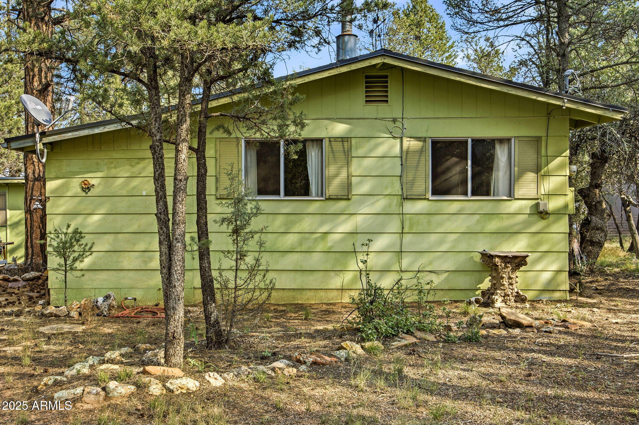 2887 Center Road Overgaard, AZ 85933 - Photo 17 of 31 a view of a brick house with large windows