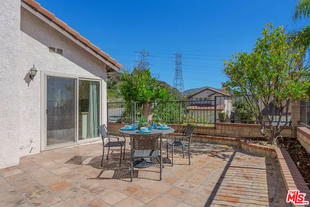 a view of a patio with a table and chairs