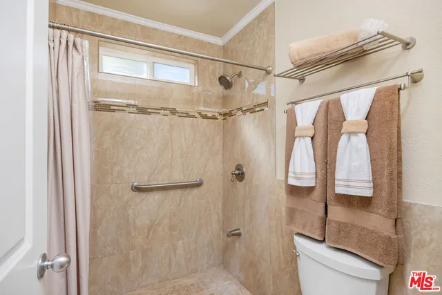 a bedroom with bed couch and window