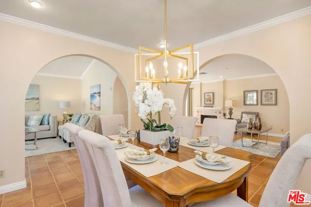 a view of a dining room with furniture a chandelier and wooden floor
