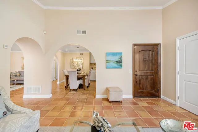 a living room with furniture and kitchen view