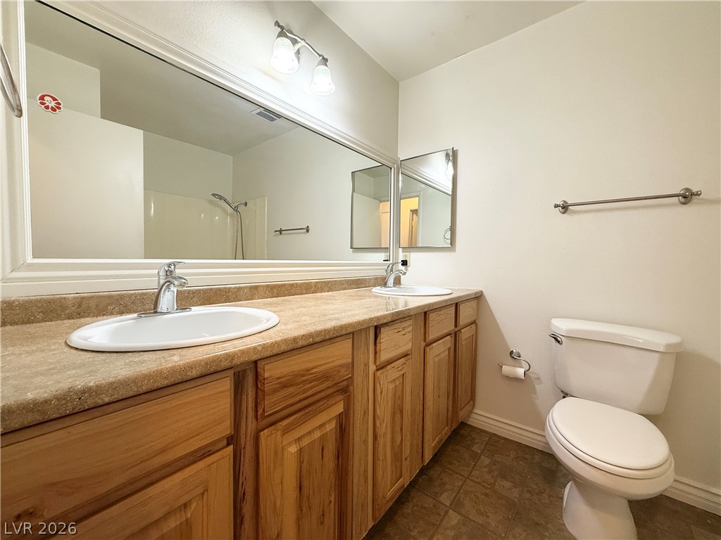 616 Greenway Road Henderson, NV 89002 - Photo 27 of 32 Double vanity sinks and spacious countertops highlight this well-appointed bathroom.