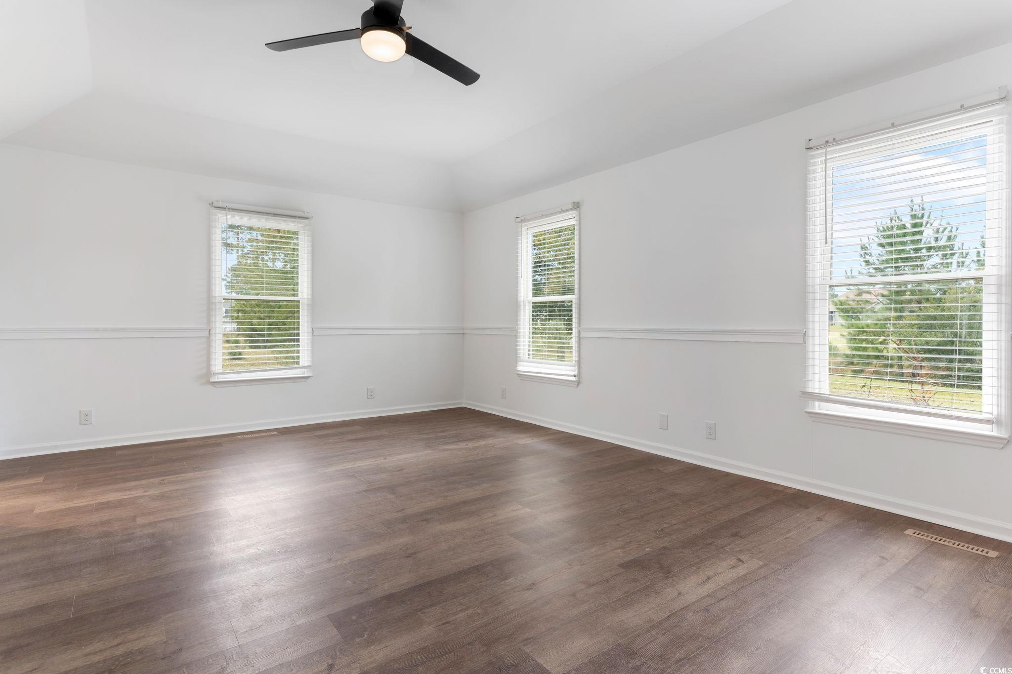 2321 Brick Drive Longs, SC 29568 - Photo 21 of 40 Empty room with dark wood finished floors, ceiling fan, and vaulted ceiling