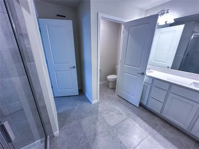 a view of a room with cabinet and mirror