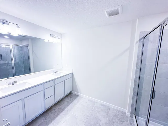 a bathroom with a double vanity sink and mirror