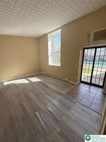 a view of an empty room with glass door