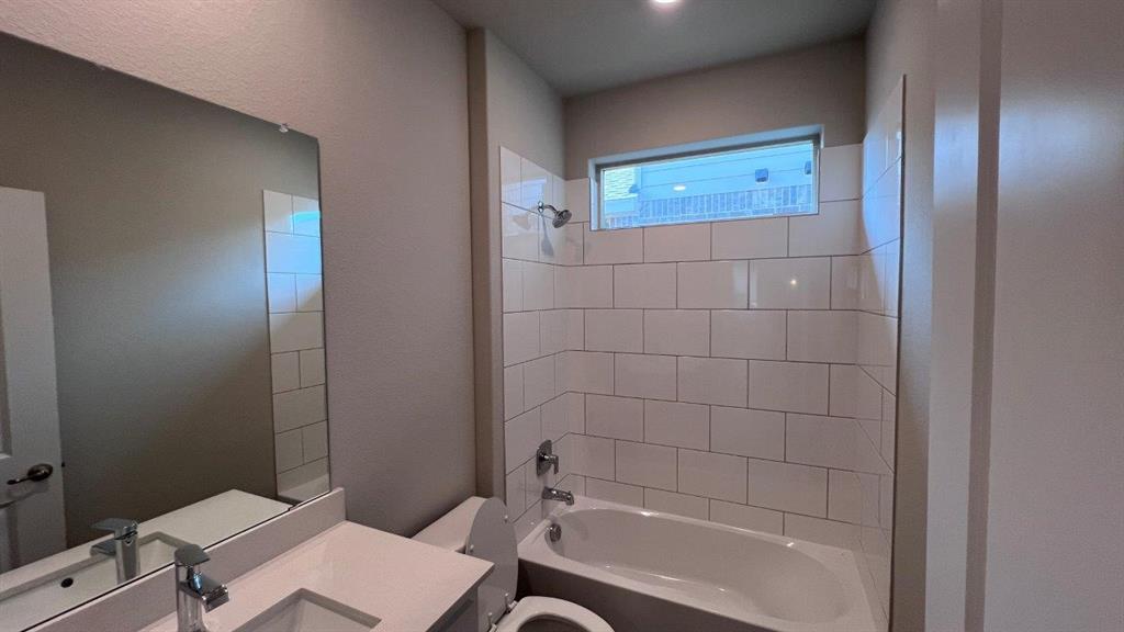 138 Stanton Avenue Rhome, TX 76078 - Photo 11 of 19 a bathroom with a bathtub and a toilet