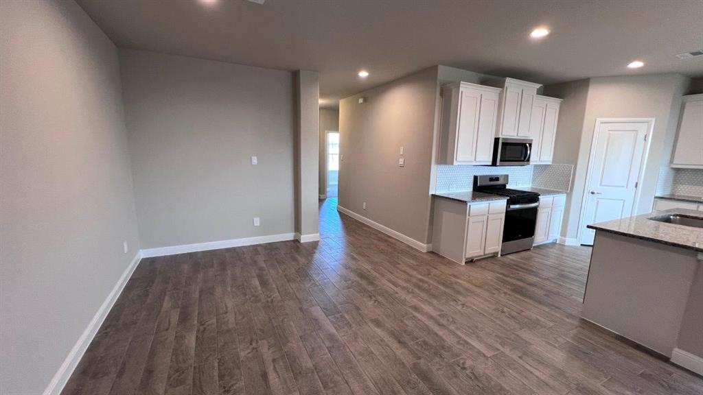 138 Stanton Avenue Rhome, TX 76078 - Photo 4 of 19 a view of kitchen with sink and refrigerator