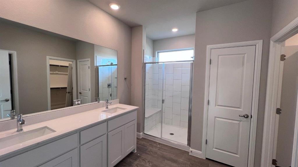 138 Stanton Avenue Rhome, TX 76078 - Photo 8 of 19 a bathroom with double sink and a mirror