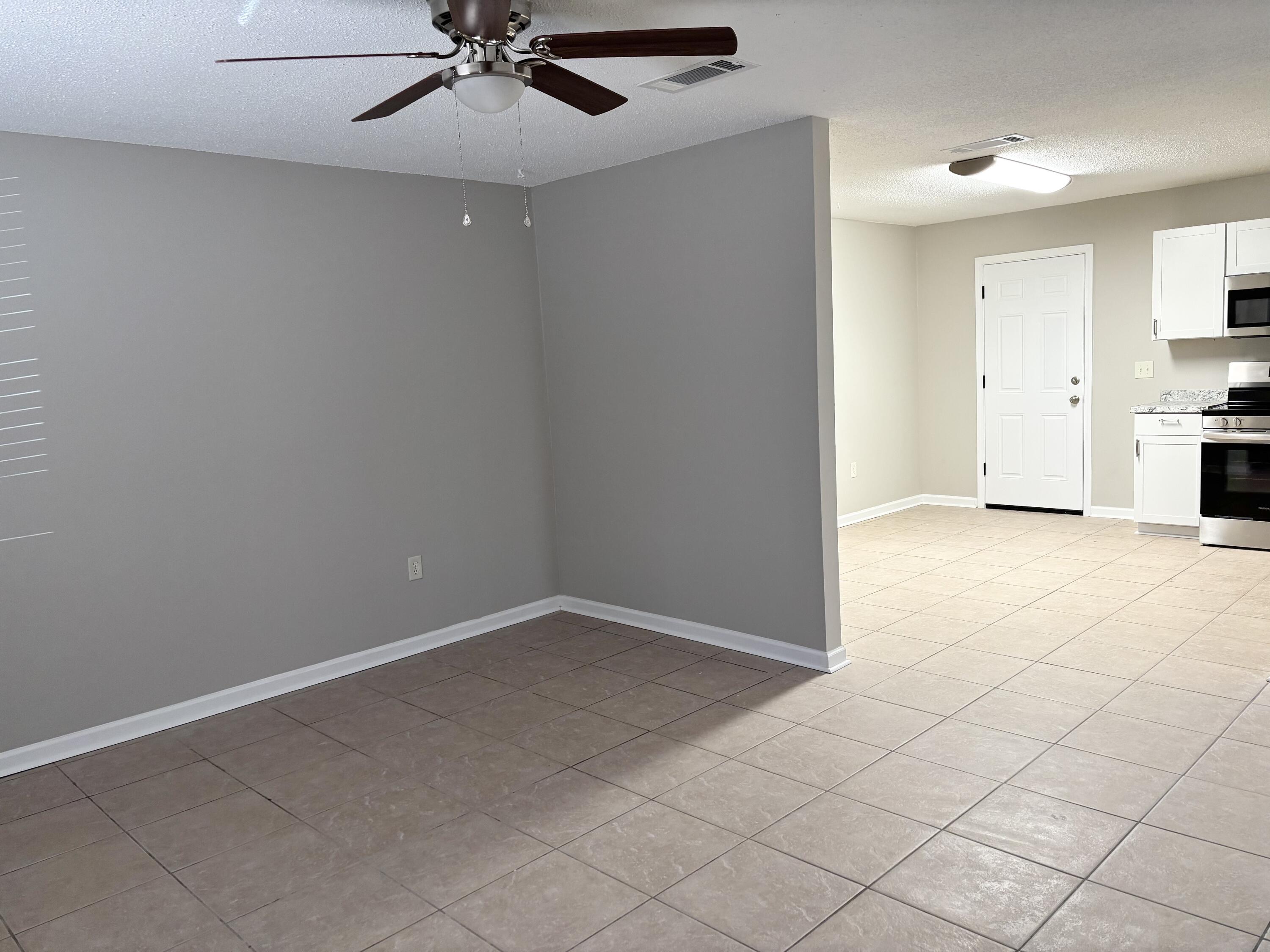 316 Lewis Street, Unit D Fort Walton Beach, FL 32547 - Photo 2 of 9 an empty room with fan and entrance