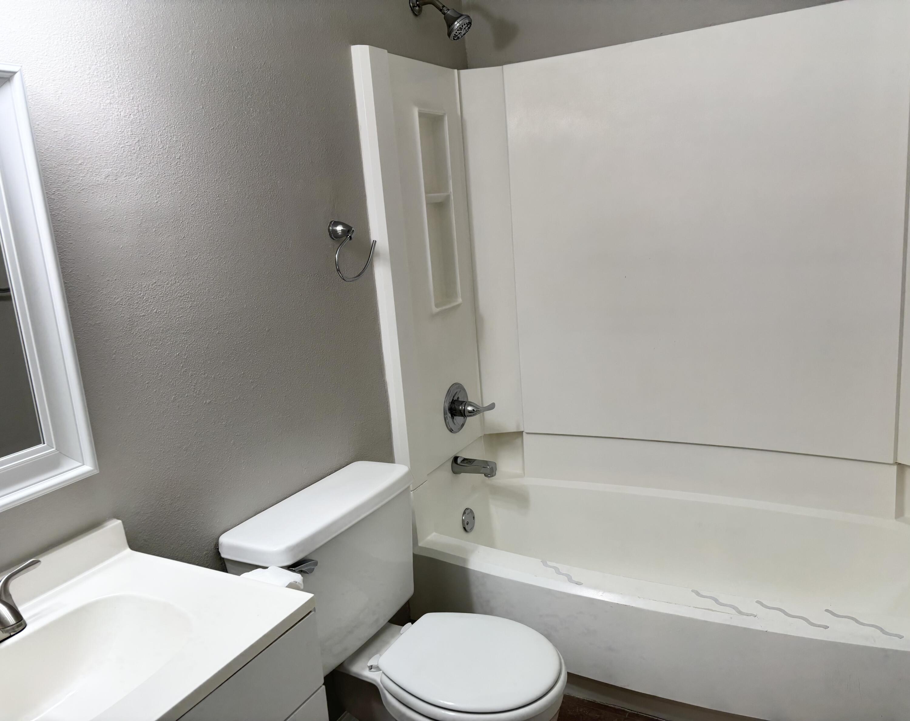 316 Lewis Street, Unit D Fort Walton Beach, FL 32547 - Photo 8 of 9 a toilet sitting next to a bath tub