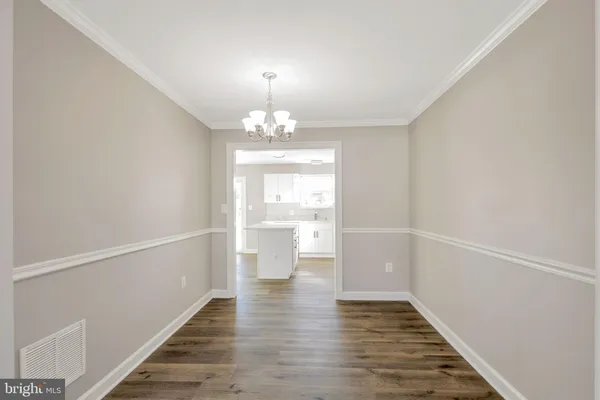 a view of a room with wooden floor and staircase