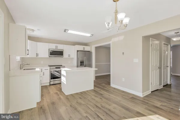 a view of kitchen with furniture and wooden floor
