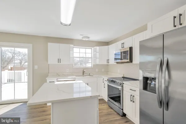 a kitchen with a sink stove and refrigerator