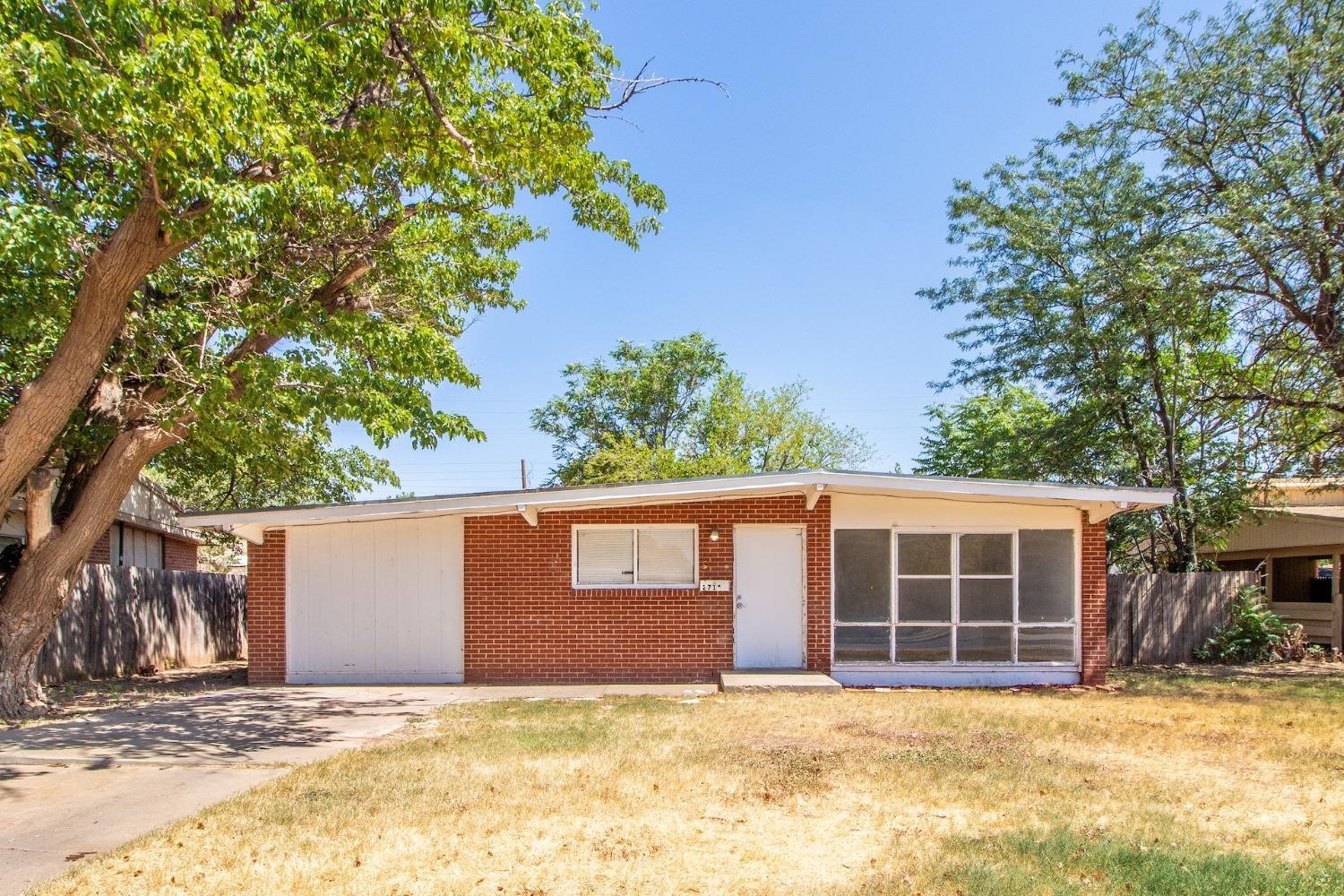 2714 62nd Street Lubbock, TX 79413 - Photo 1 of 28 a view of a house with a yard