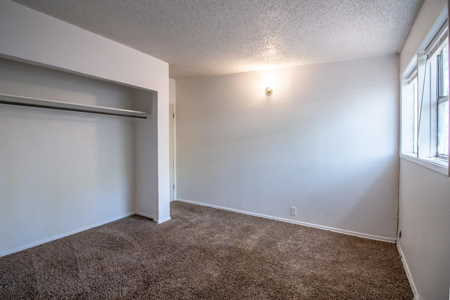 2714 62nd Street Lubbock, TX 79413 - Photo 17 of 28 an empty room with windows and closet