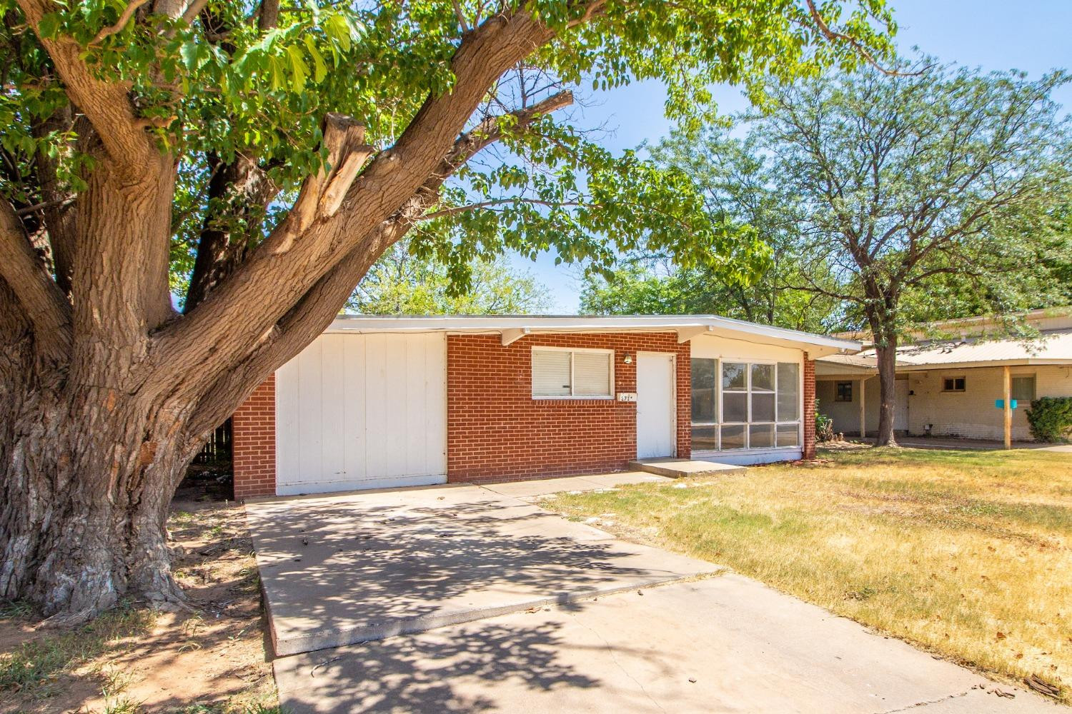 2714 62nd Street Lubbock, TX 79413 - Photo 2 of 28 a front view of a house with a yard