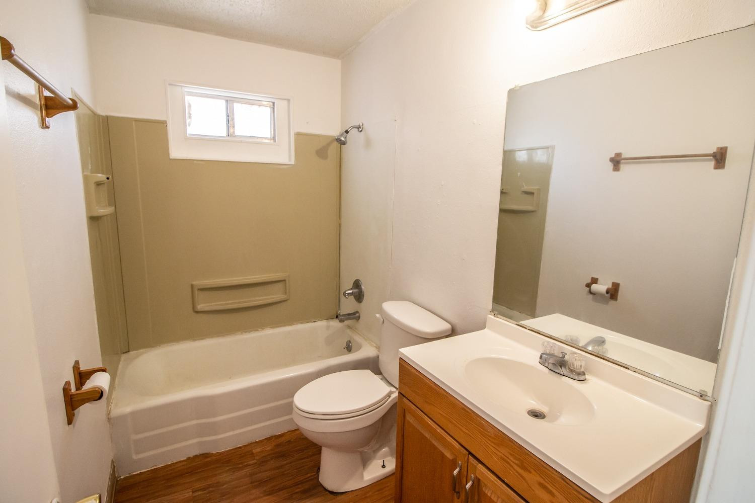 2714 62nd Street Lubbock, TX 79413 - Photo 23 of 28 a bathroom with a sink a toilet and shower