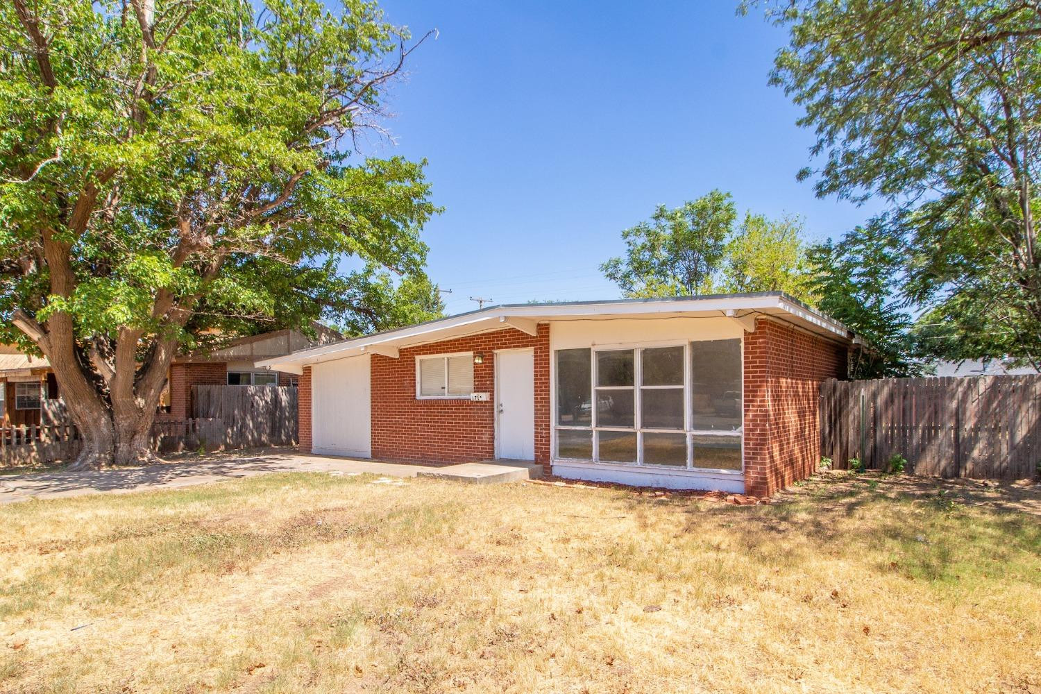 2714 62nd Street Lubbock, TX 79413 - Photo 3 of 28 a view of a house with a yard