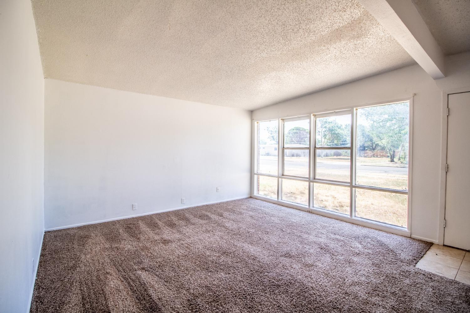 2714 62nd Street Lubbock, TX 79413 - Photo 8 of 28 a view of an empty room with a window