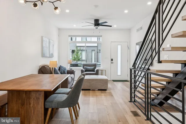 a dining room with furniture and wooden floor
